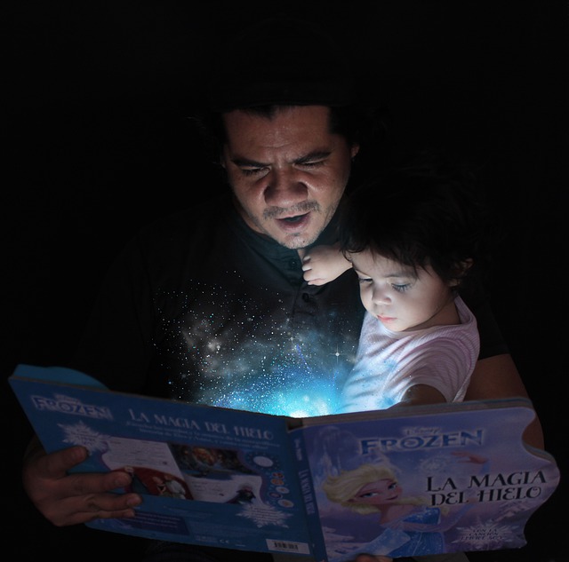kid reading at night in bed with a reading light