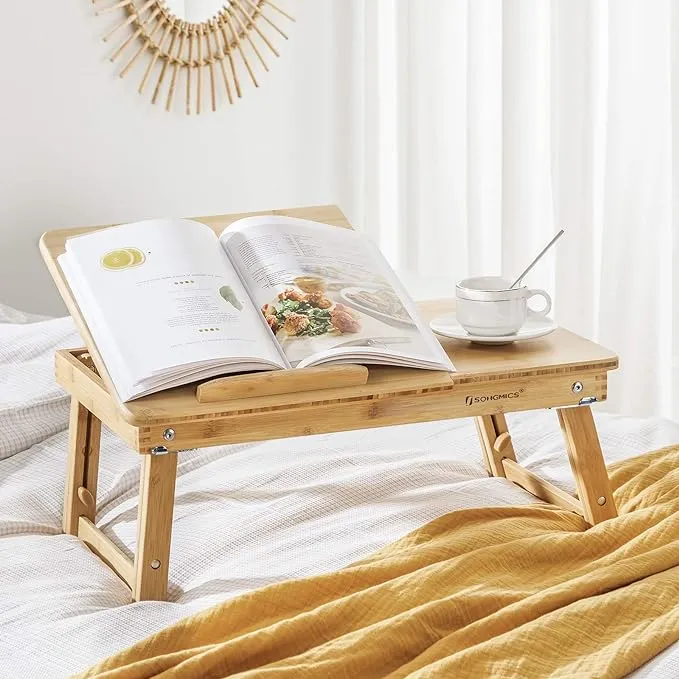 The Songmics bamboo wooden over-bed table is a sturdy, adjustable, and stylish book-reading table for the bed with a practical side drawer.