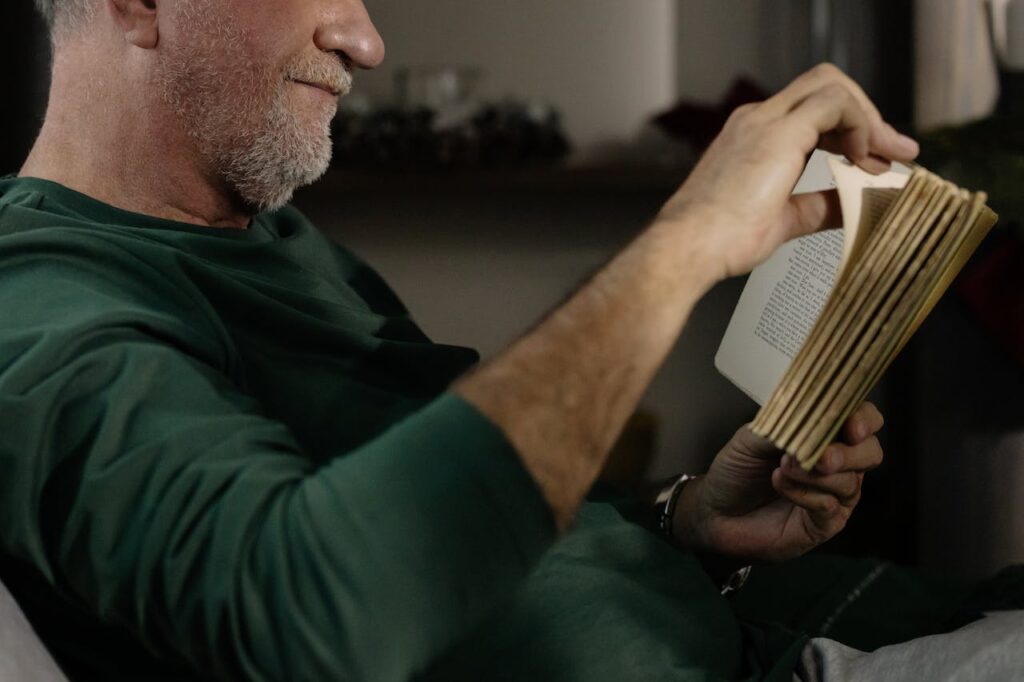 An elderly person is reading a book